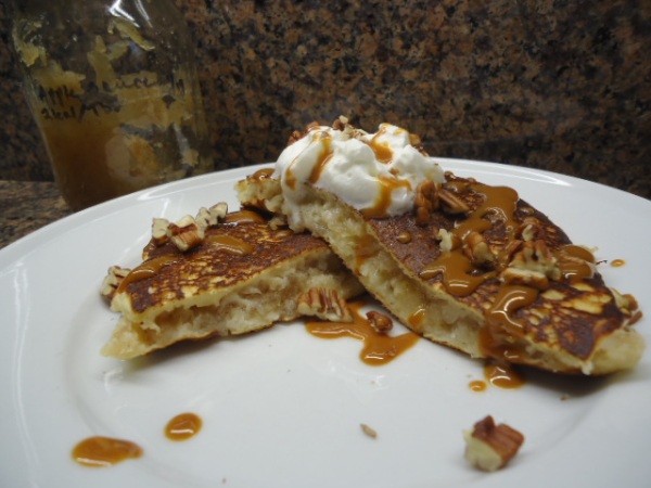 Homemade Chunky Apple Sauce stuffed Pancakes, topped with Caramel Sauce, chopped Pecans and whipped cream